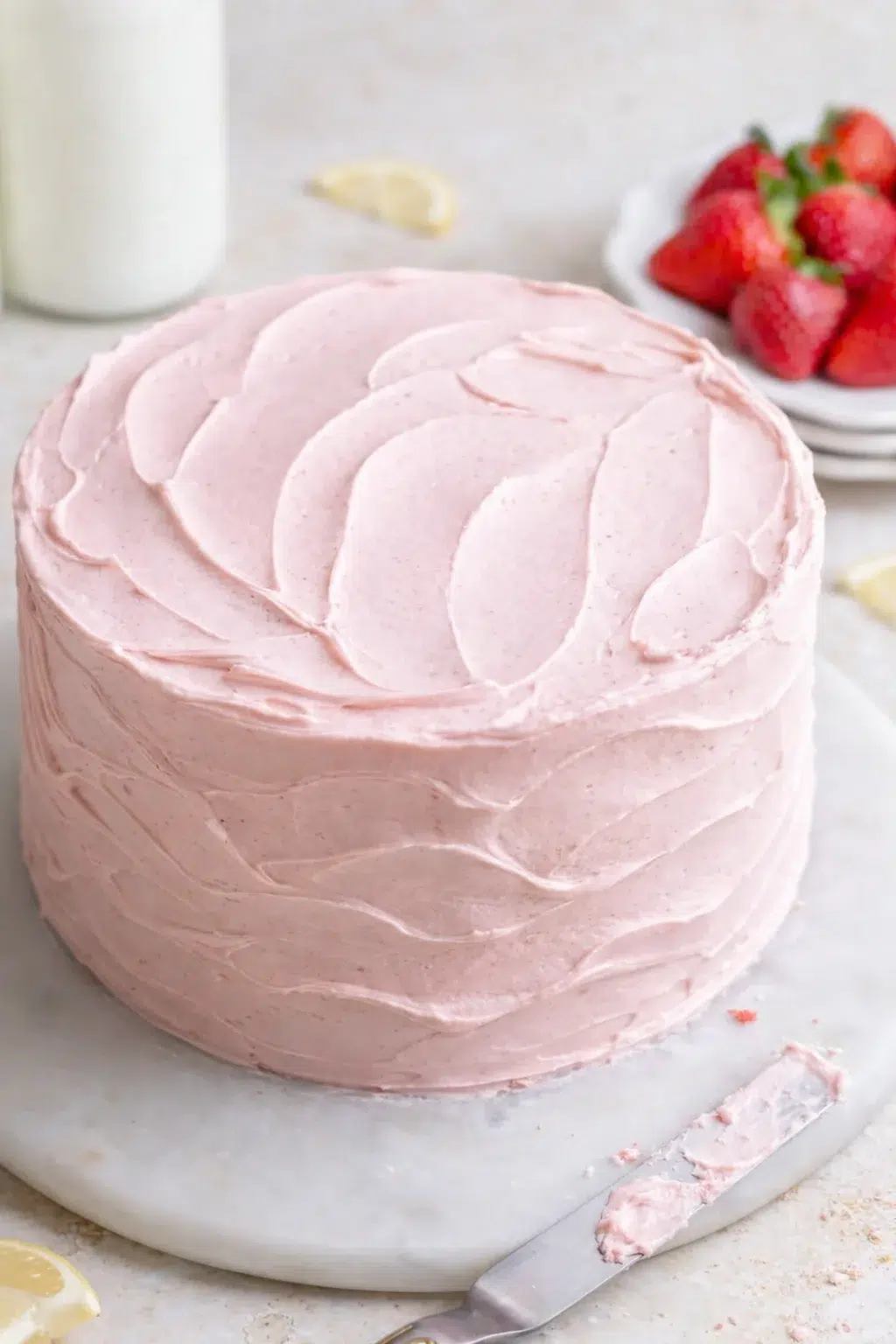 step-process-placeholder-17-17.png Frosted cake being smoothed with an offset spatula, creating decorative wavy spatula patterns.