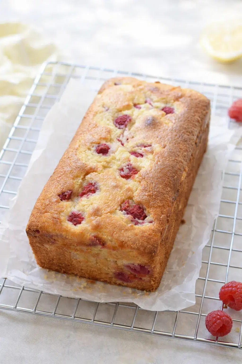 step-process-placeholder-9-9.png Loaf lifted on wire rack with parchment being peeled away, cooling completely before slicing