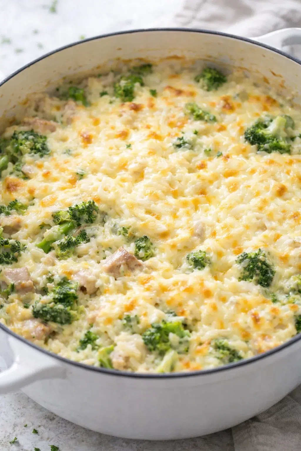 step-process-placeholder-9-9.png Casserole surface smoothed, half the cheese stirred in, remaining cheese sprinkled and beginning to brown.