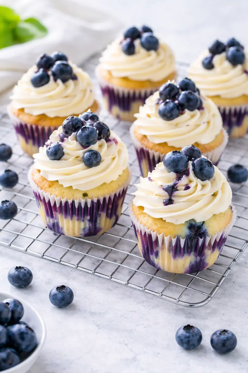 step-process-placeholder-13-13.png Cupcakes cooling on wire rack after brief rest in the muffin pan.