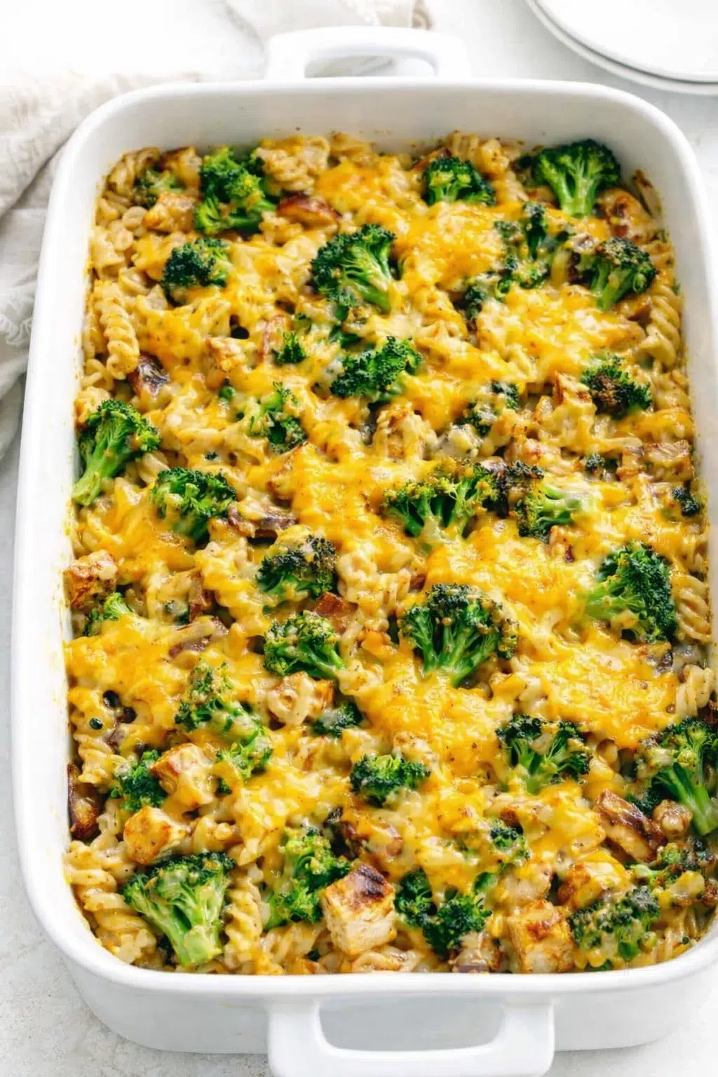 step-process-placeholder-13-16.png 9x13-inch baking dish filled with pasta, broccoli, chicken, coated in creamy sauce, shredded cheddar topping.