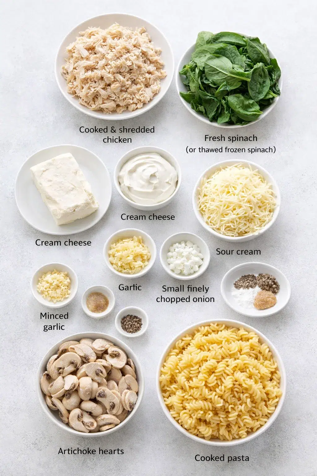 ingredients-placeholder.png Measured ingredients arranged for Creamy Chicken and Spinach Casserole: A Comforting Dish for Any Occasion: Cooked and shredded chicken, Fresh spinach (or thawed frozen spinach), Cream cheese, softened, Sour cream, Shred