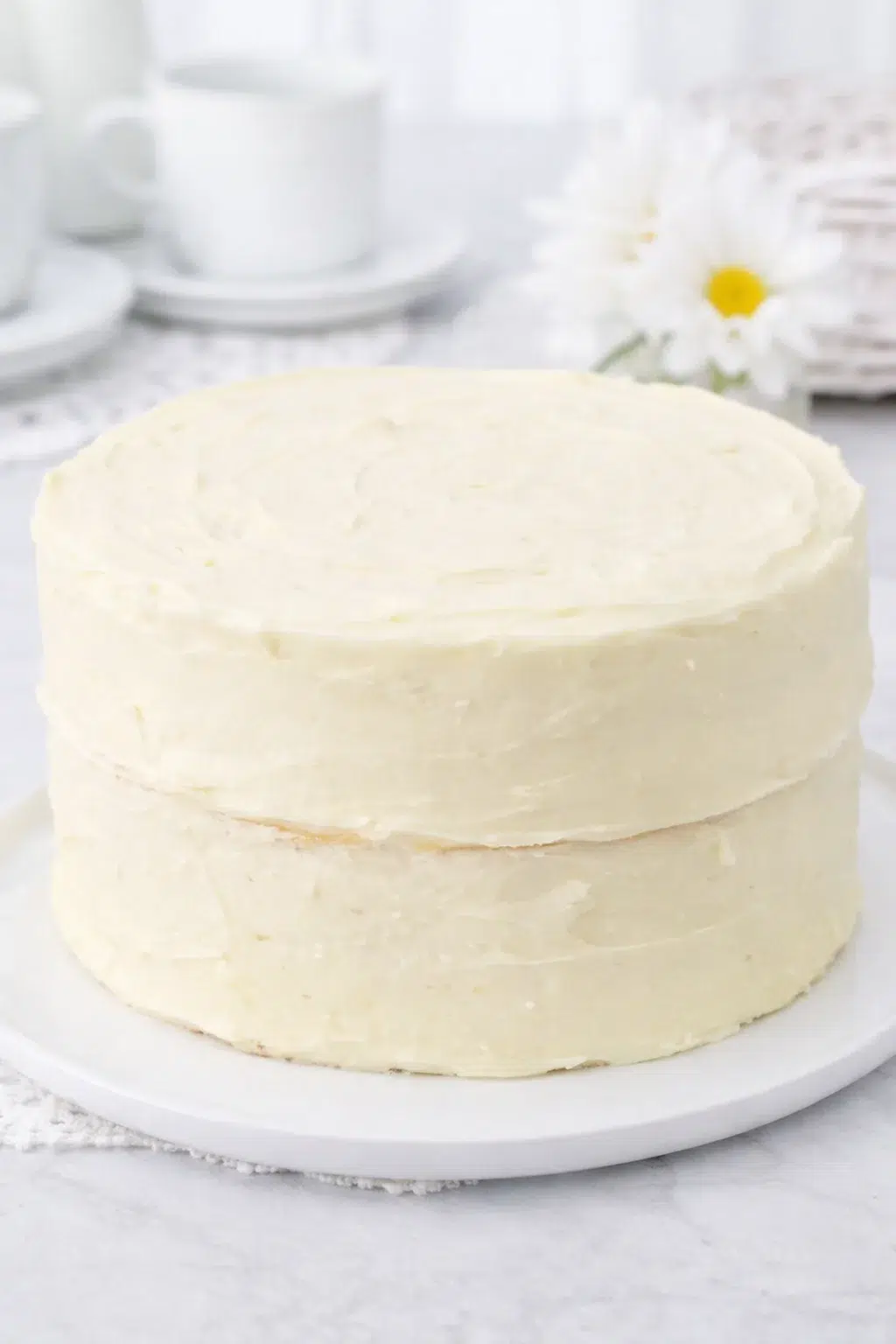 step-process-placeholder-17-17.png Assembling and frosting two cake layers, hand smoothing frosting with offset spatula on turntable.