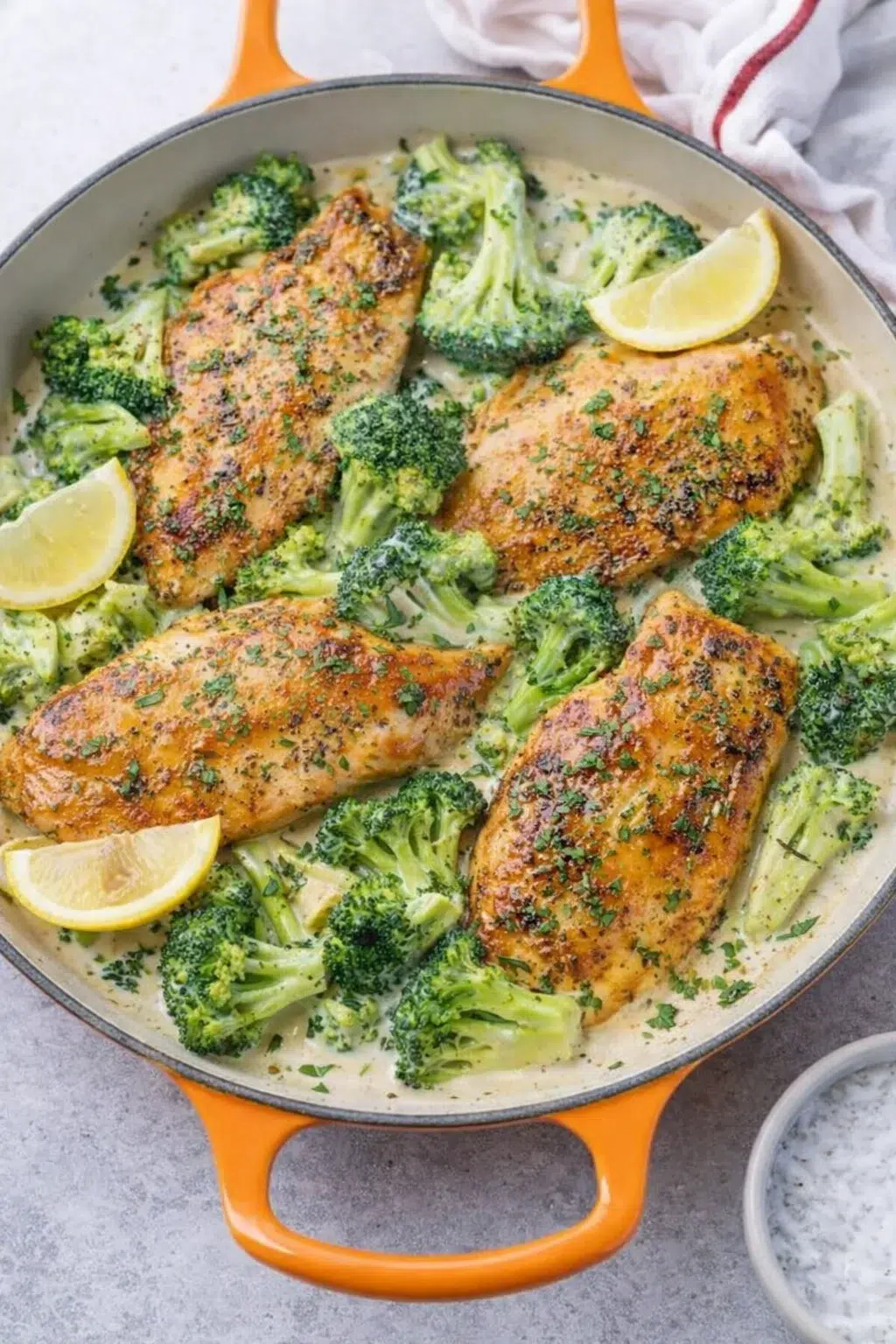 step-process-placeholder-9-11.png Broccoli simmering in creamy sauce with chicken nestled back in skillet, topped with chopped parsley
