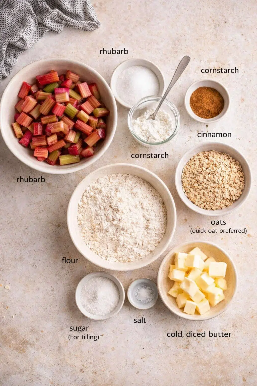 Measured ingredients arranged for Easy Rhubarb Crisp Recipe [+ Video] - Savory Nothings: Rhubarb (sliced; fresh or frozen), Sugar (for filling), Cornstarch, Cinnamon (for filling and topping), Flour, Oats (quick oats pre