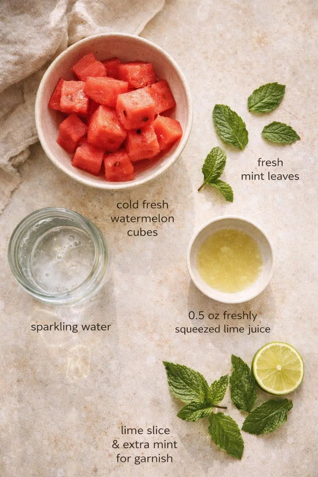 Measured ingredients arranged for Watermelon Mint Mojito Mocktail: 1 cup cold fresh watermelon cubes, 6 fresh mint leaves, 0.5 oz freshly squeezed lime juice, Lime slice and extra mint leaves for garnish, Sparkling water
