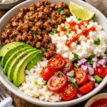 High protein cottage cheese beef bowl with rice, avocado and fresh vegetables