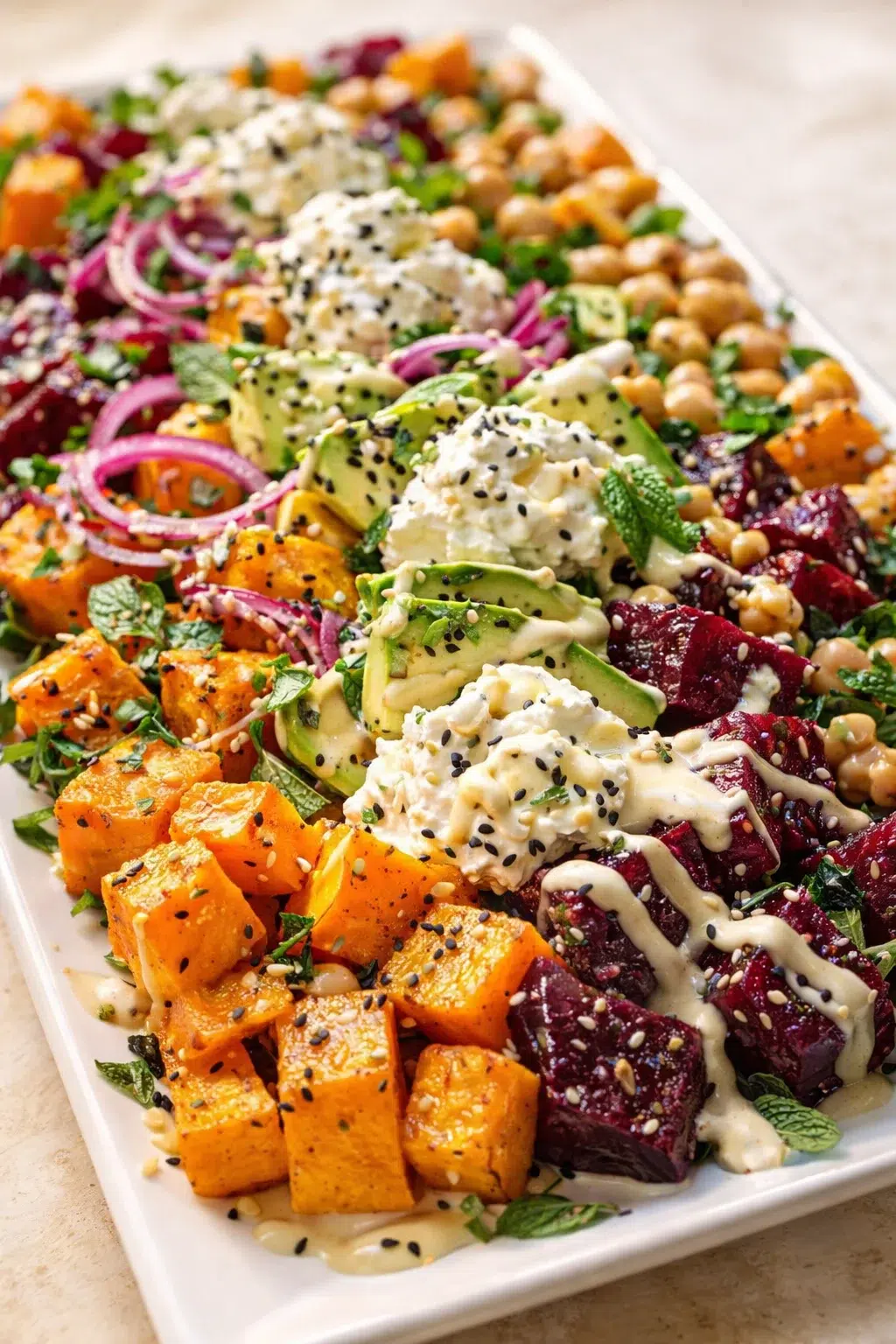 roasted beet sweet potato avocado salad with whipped ricotta and lemon tahini drizzle