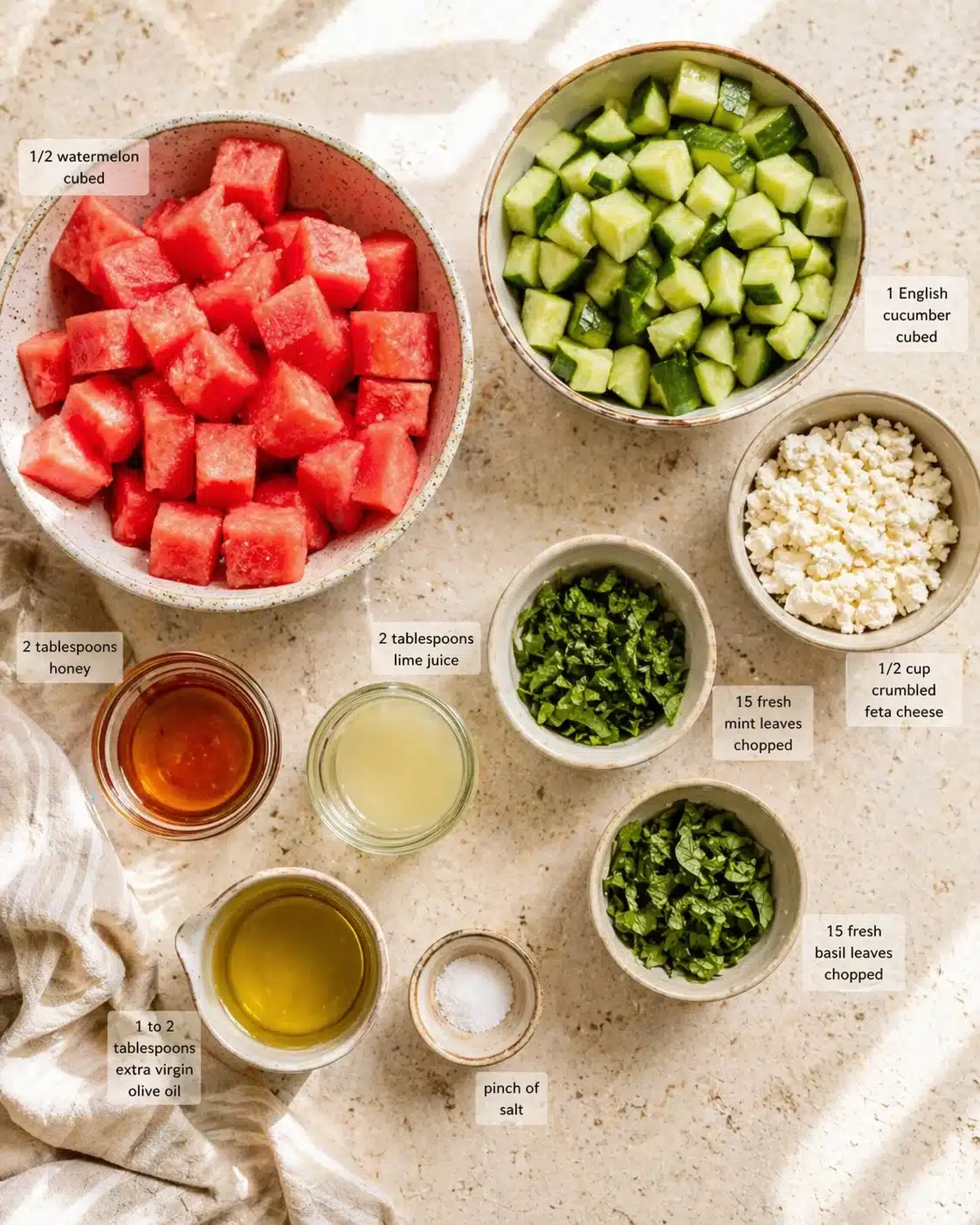 Measured ingredients arranged for Watermelon Salad with Feta, Cucumber and Mint | The Mediterranean Dish: 2 tablespoons honey, 2 tablespoons lime juice, 1 to 2 tablespoons quality extra virgin olive oil, pinch of salt, 1